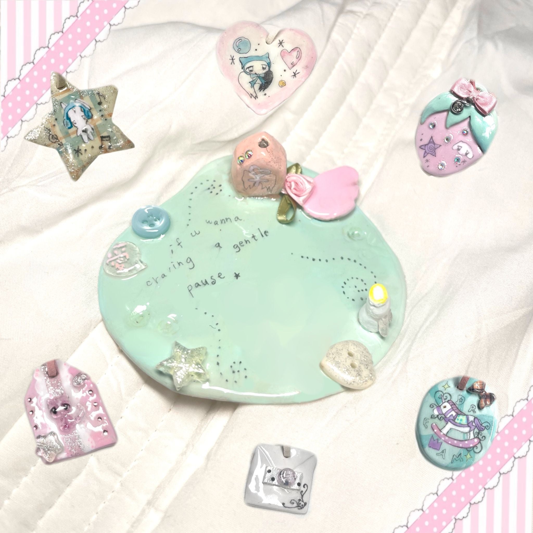 Pastel handmade decorative textile and resin charms on fabric