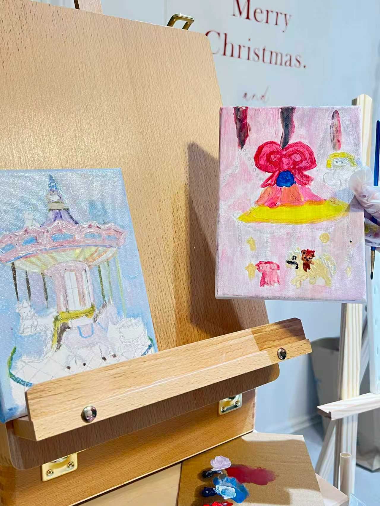 Small paintings arranged on a wooden easel